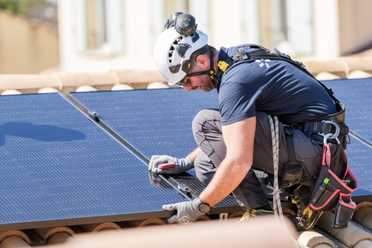 installateur EDF solutions solaires entrain de poser des panneaux chez un client particulier