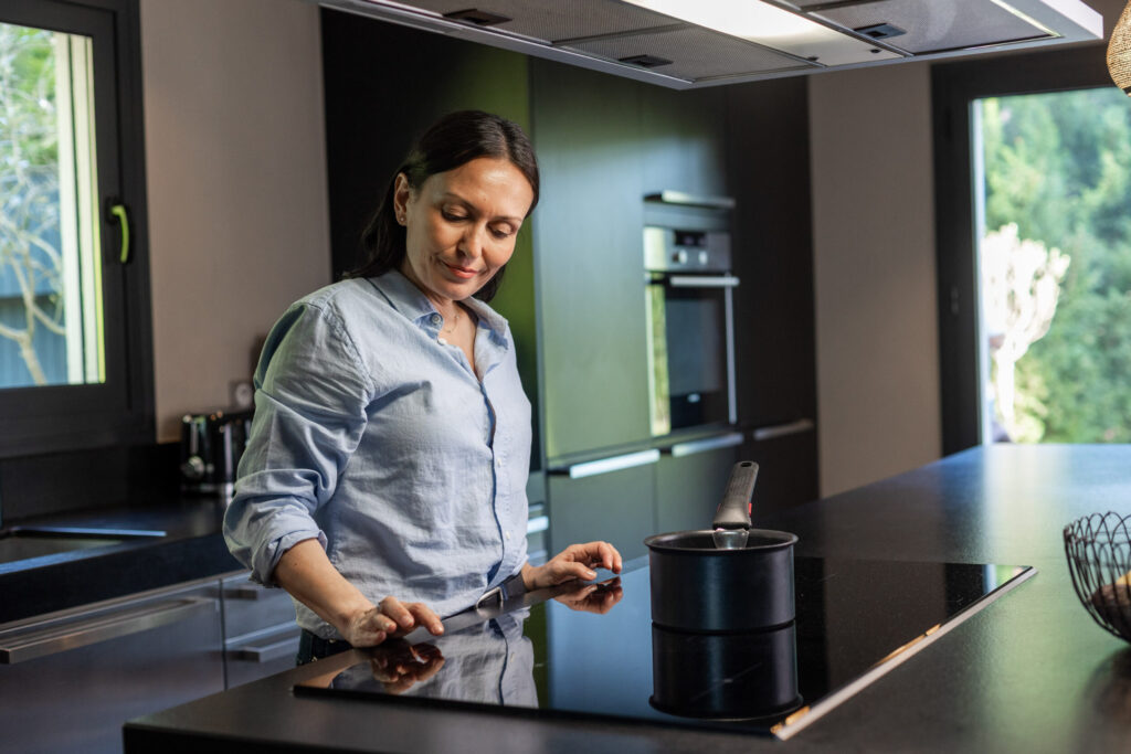 femme dans sa cuisine qui prépare un repas